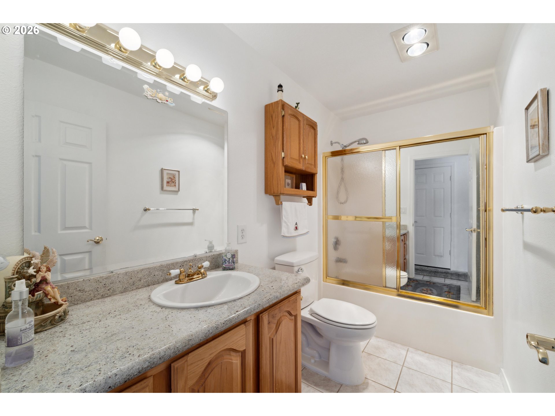 805 Lisa Place Coos Bay, OR 97420 - Photo 24 of 47 a bathroom with a sink a toilet a mirror and shower