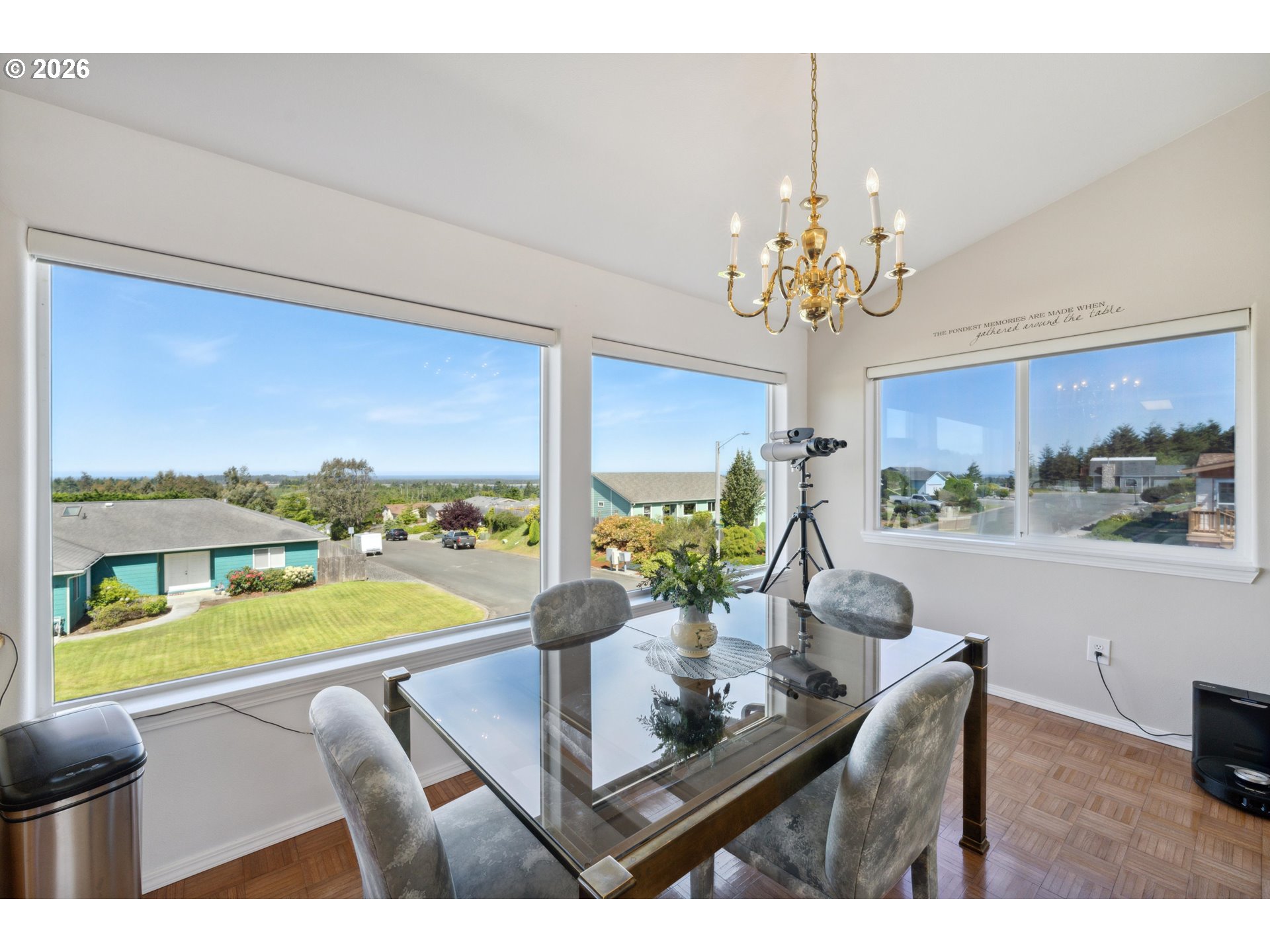 805 Lisa Place Coos Bay, OR 97420 - Photo 9 of 47 a view of a dining room with furniture a chandelier and large windows
