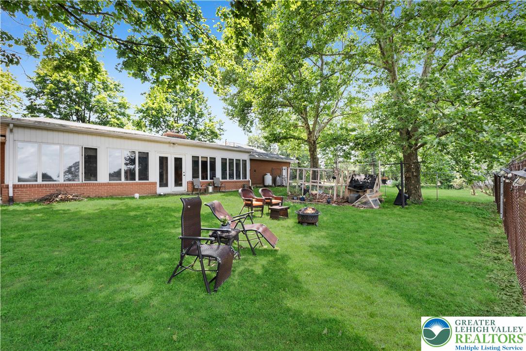 5747 Kernsville Road Orefield, PA 18069 - Photo 45 of 56 a view of a house with a backyard and a patio