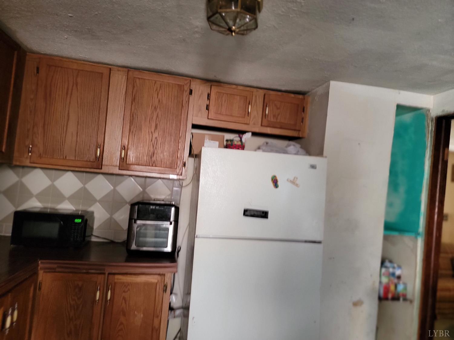 6097 Wards Road Hurt, VA 24563 - Photo 2 of 7 a white refrigerator freezer sitting inside of a kitchen