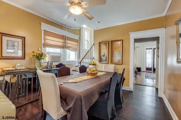a view of a dining room with furniture window and wooden floor