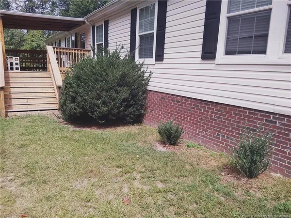 a view of house with backyard and garden