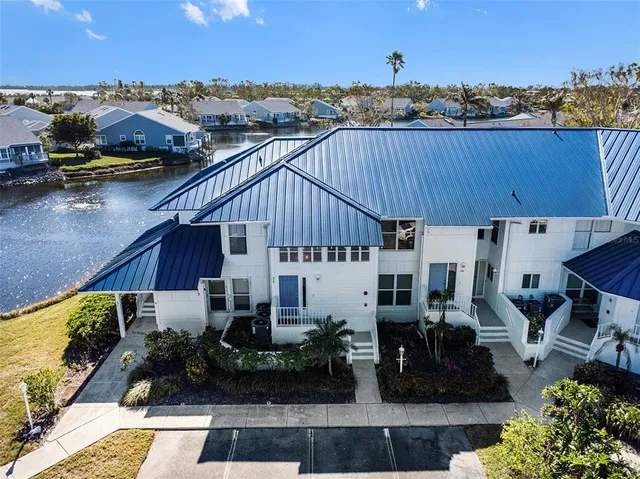 an aerial view of a house with swimming pool and outdoor seating