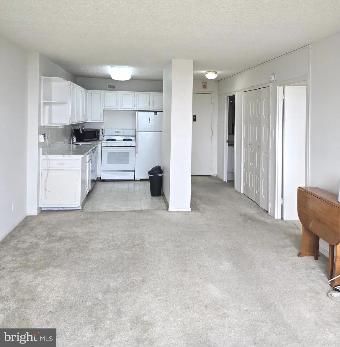 5225 Pooks Hill Road, Unit 1814N Bethesda, MD 20814 - Photo 29 of 52 a view of a kitchen with refrigerator and chairs