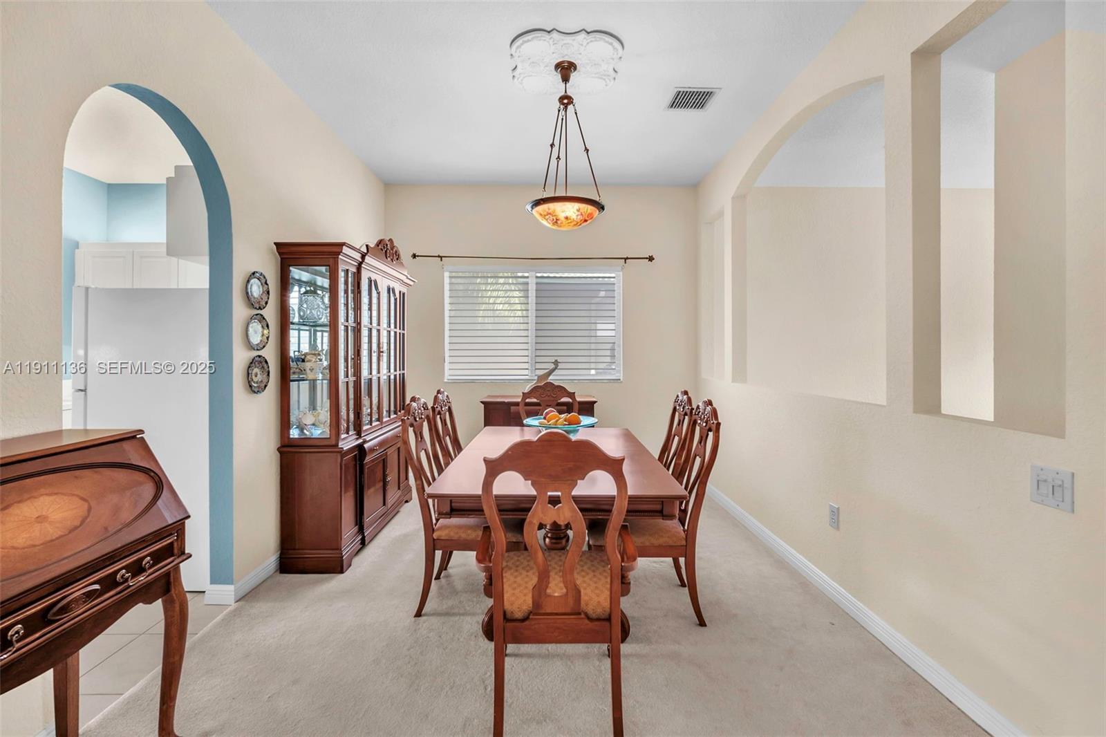7921 Exeter Boulevard East, Unit 202 Tamarac, FL 33321 - Photo 16 of 55 a view of a dining room with furniture and chandelier