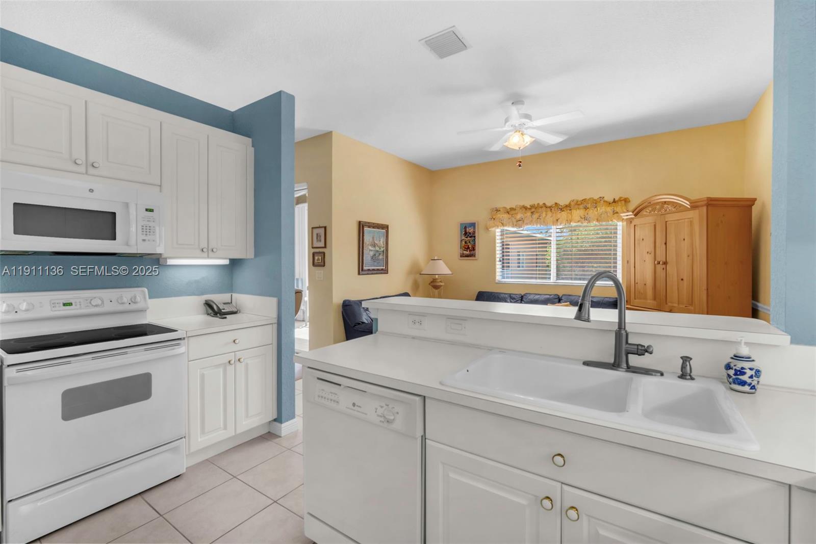 7921 Exeter Boulevard East, Unit 202 Tamarac, FL 33321 - Photo 19 of 55 a kitchen with stainless steel appliances granite countertop a sink and cabinets