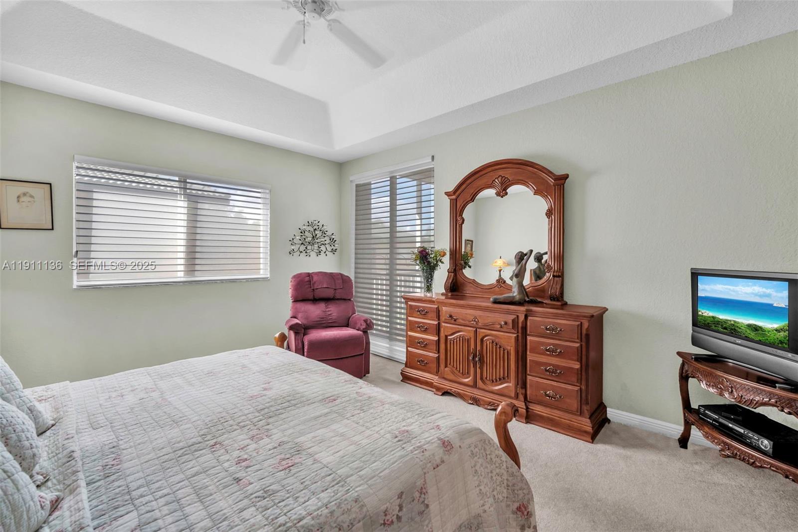 7921 Exeter Boulevard East, Unit 202 Tamarac, FL 33321 - Photo 24 of 55 a bedroom with a bed and a dresser