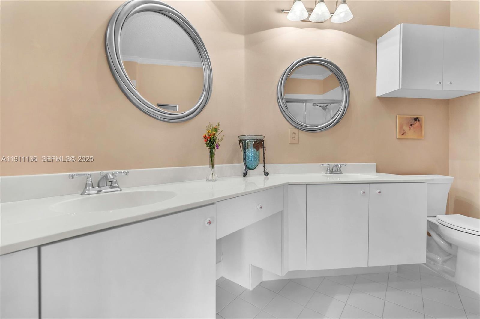 7921 Exeter Boulevard East, Unit 202 Tamarac, FL 33321 - Photo 26 of 55 a bathroom with a toilet and a sink