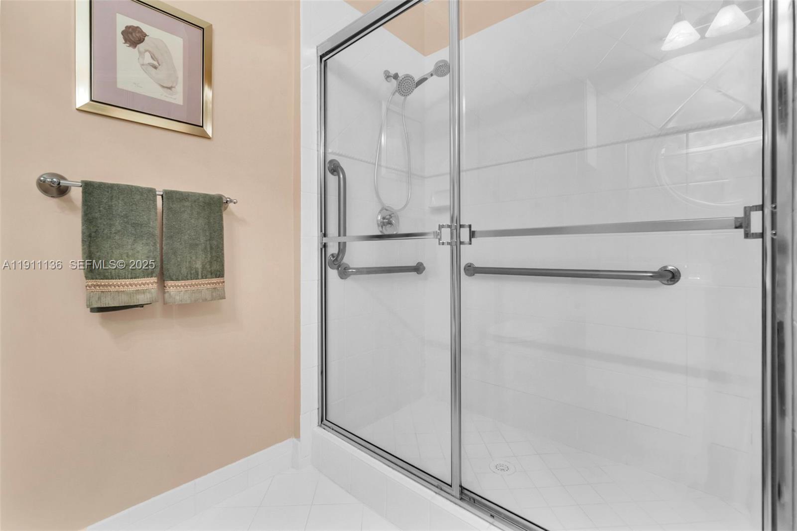 7921 Exeter Boulevard East, Unit 202 Tamarac, FL 33321 - Photo 27 of 55 a bathroom with a glass shower door
