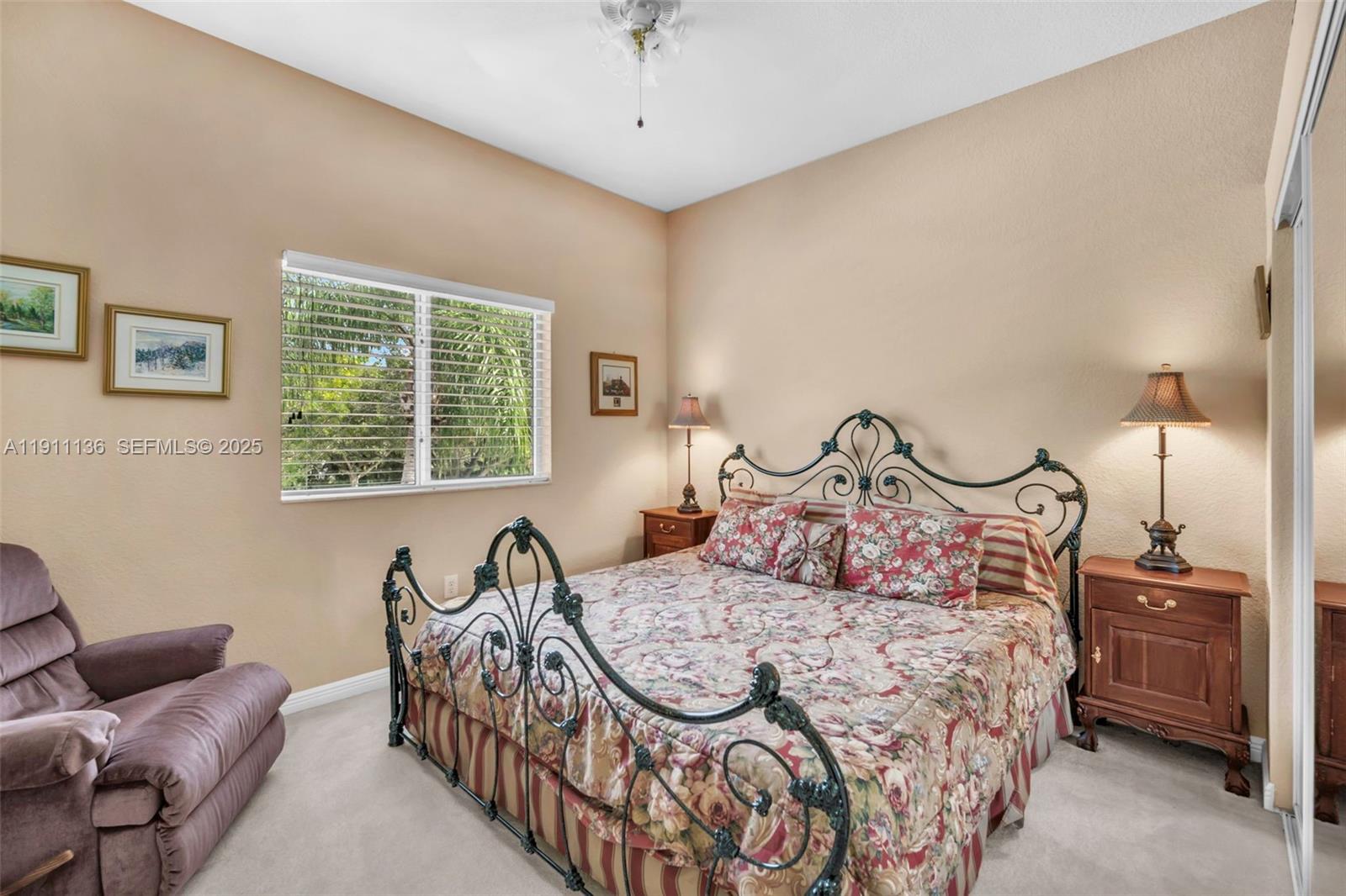7921 Exeter Boulevard East, Unit 202 Tamarac, FL 33321 - Photo 28 of 55 a bedroom with a bed and a couch