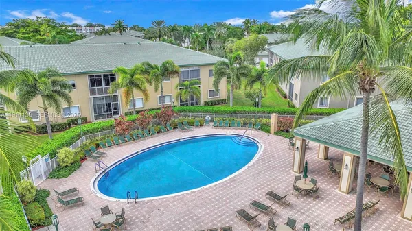 an aerial view of a house with swimming pool garden and patio
