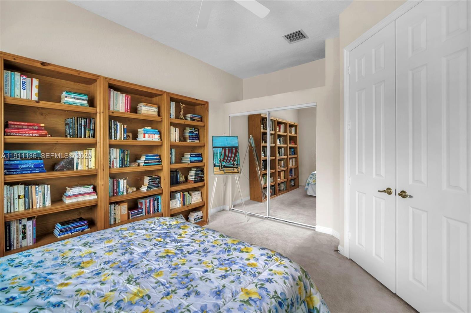 7921 Exeter Boulevard East, Unit 202 Tamarac, FL 33321 - Photo 31 of 55 a bedroom with a book shelf