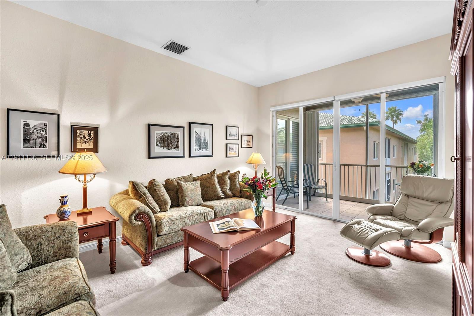 7921 Exeter Boulevard East, Unit 202 Tamarac, FL 33321 - Photo 4 of 55 a living room with furniture and a large window