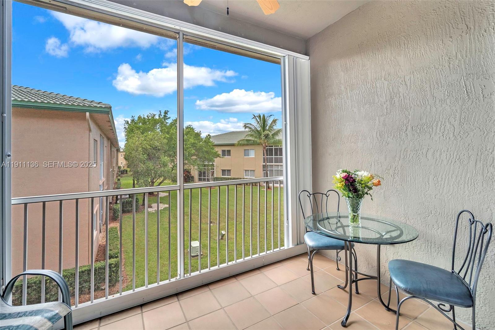 7921 Exeter Boulevard East, Unit 202 Tamarac, FL 33321 - Photo 41 of 55 a view of a balcony with furniture