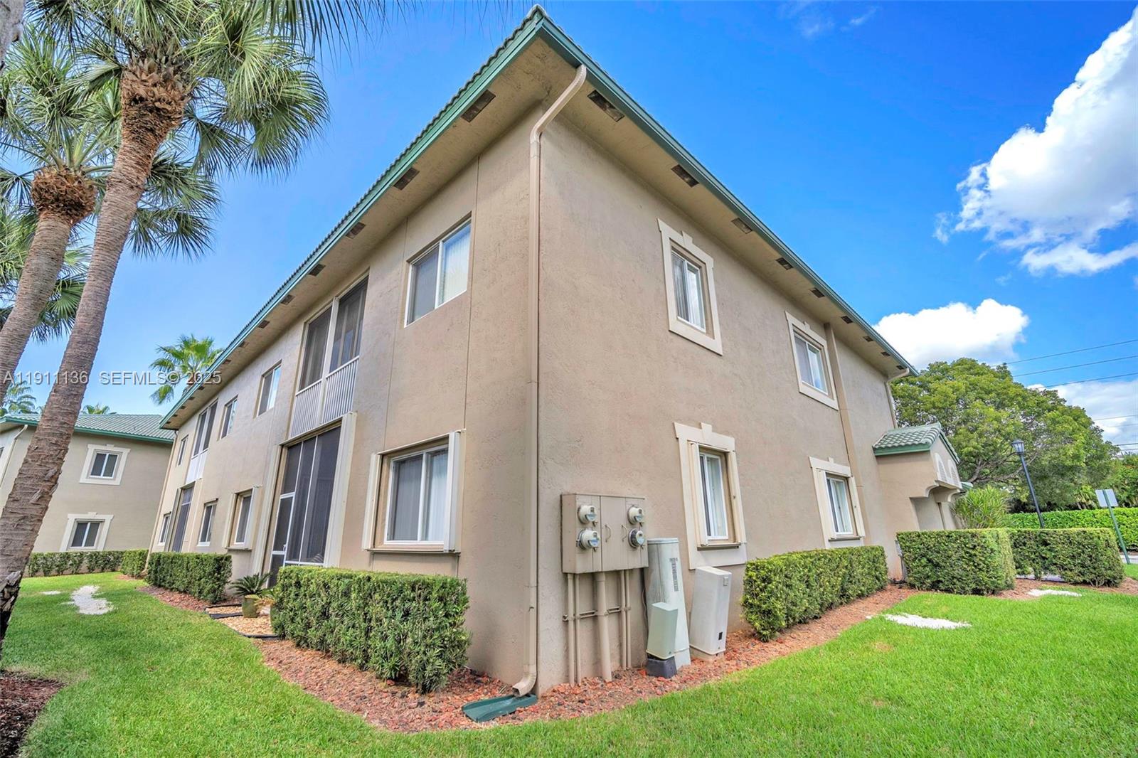 7921 Exeter Boulevard East, Unit 202 Tamarac, FL 33321 - Photo 45 of 55 a front view of a house with a yard