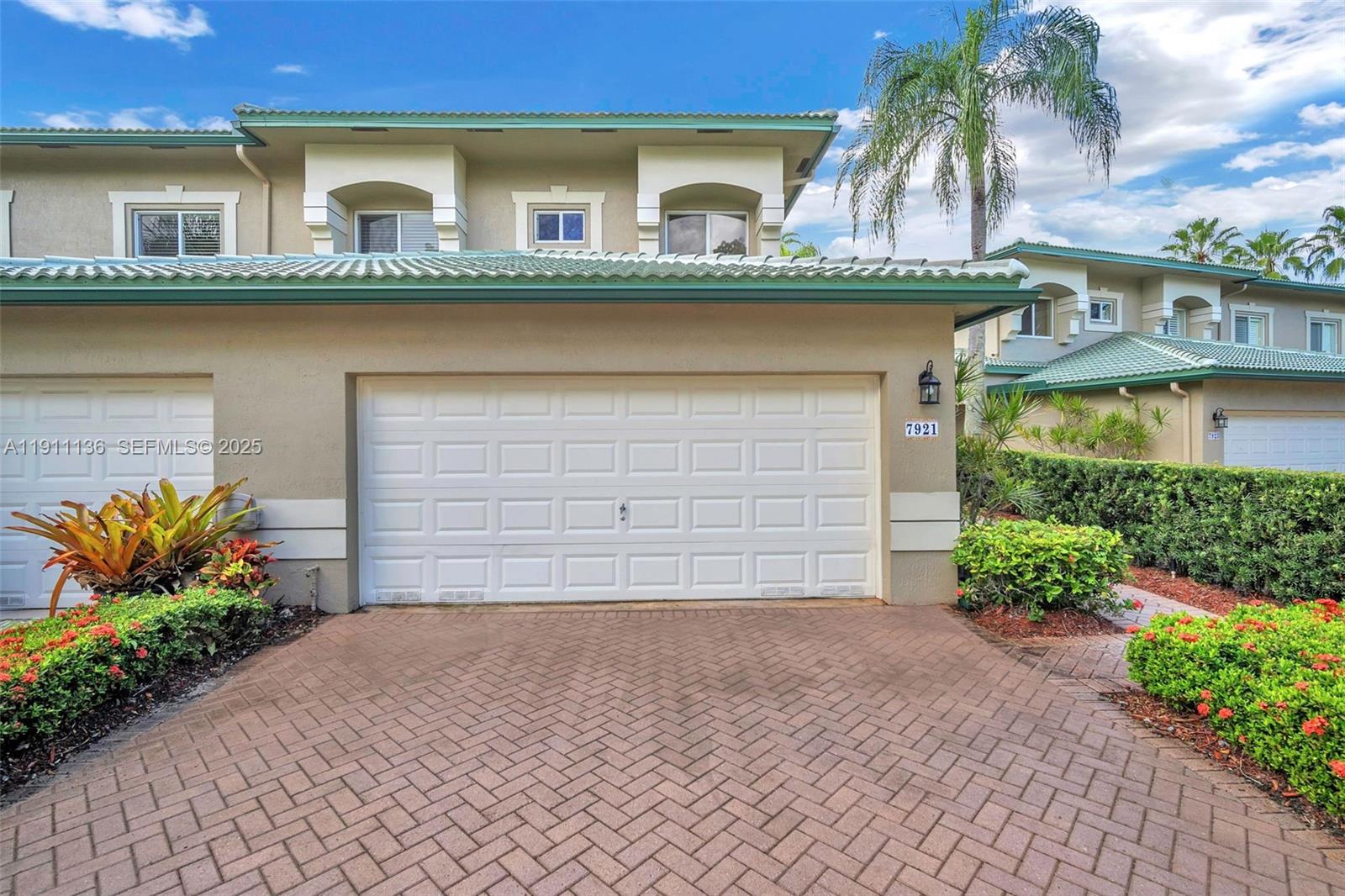 7921 Exeter Boulevard East, Unit 202 Tamarac, FL 33321 - Photo 47 of 55 a front view of house and yard with beautiful flowers