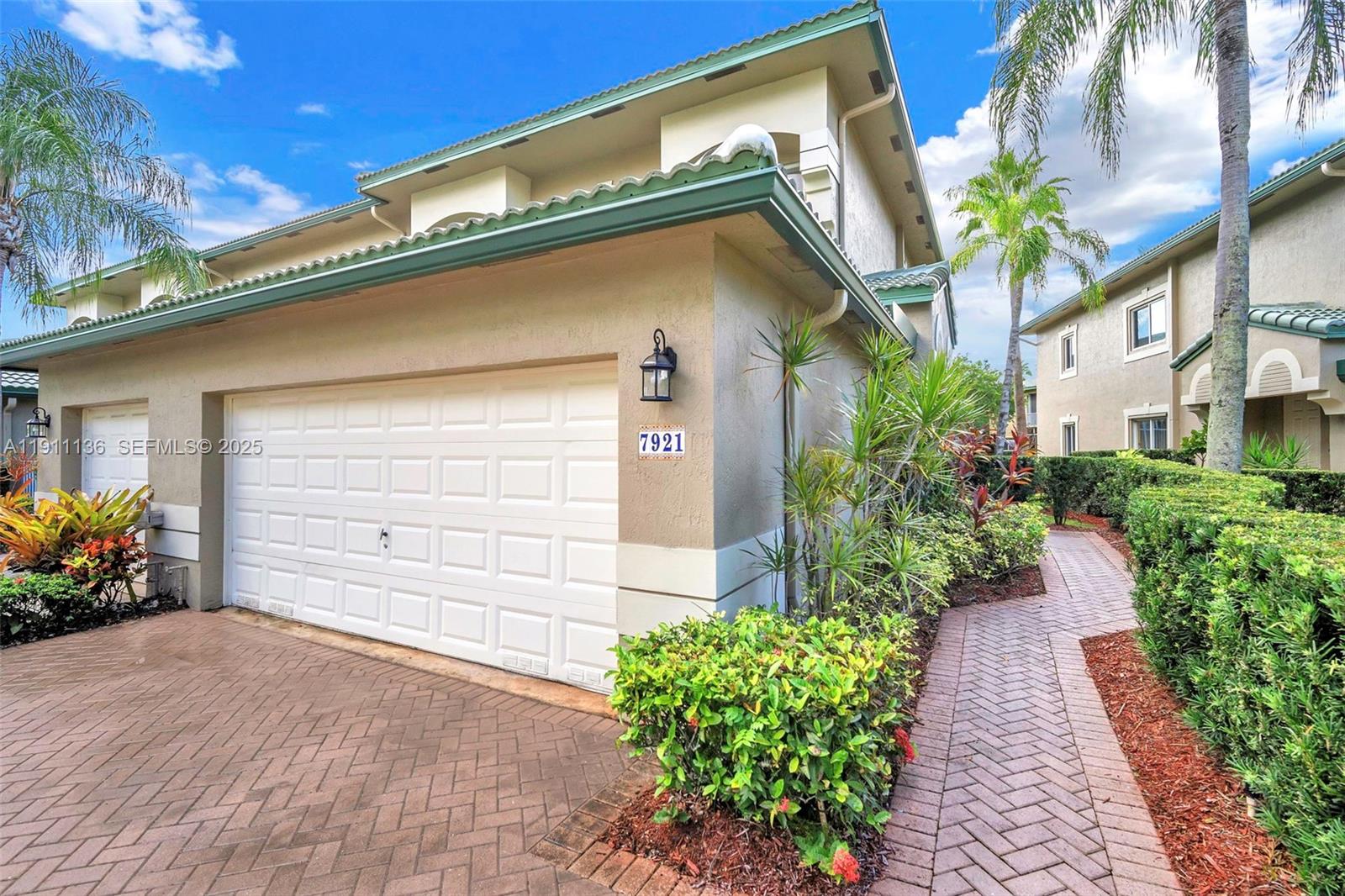 7921 Exeter Boulevard East, Unit 202 Tamarac, FL 33321 - Photo 48 of 55 a front view of a house with a garden
