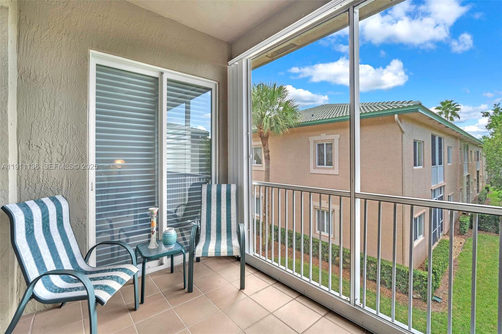 7921 Exeter Boulevard East, Unit 202 Tamarac, FL 33321 - Photo 5 of 55 a view of a two chairs in the balcony