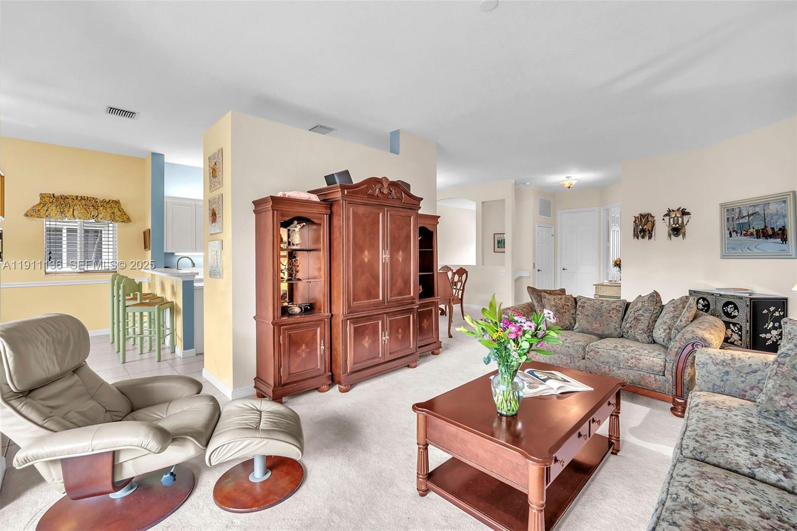 7921 Exeter Boulevard East, Unit 202 Tamarac, FL 33321 - Photo 7 of 55 a living room with furniture and wooden floor