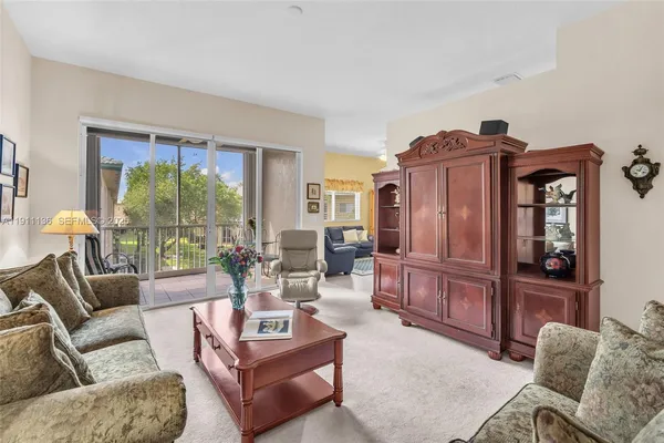 a living room with furniture and a floor to ceiling window