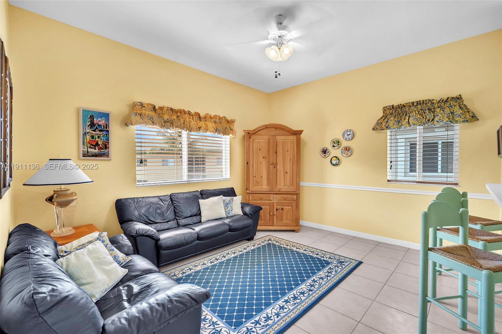 7921 Exeter Boulevard East, Unit 202 Tamarac, FL 33321 - Photo 9 of 55 a living room with furniture and a window