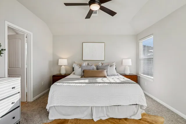 a bedroom with a bed and dresser