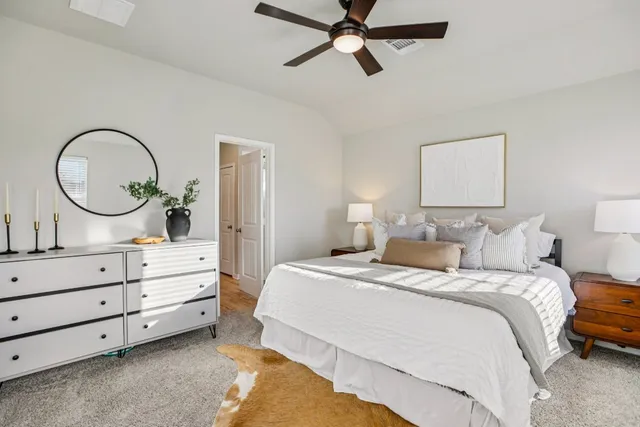 a bedroom with a bed and a dresser