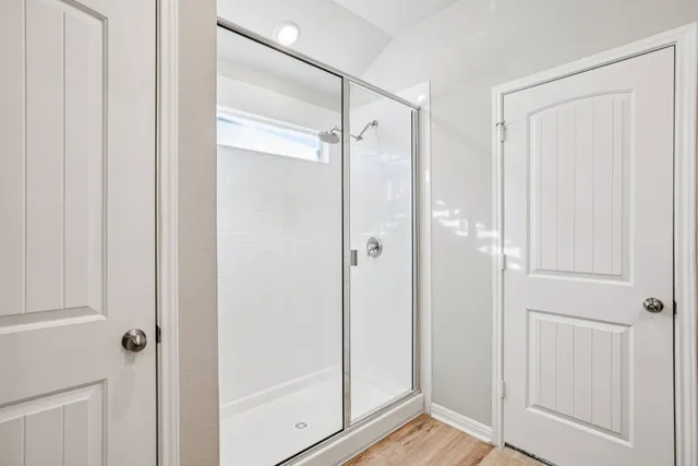 a view of a bathroom with a glass shower door