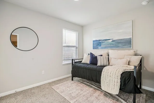 a bedroom with a bed and a painting on the wall