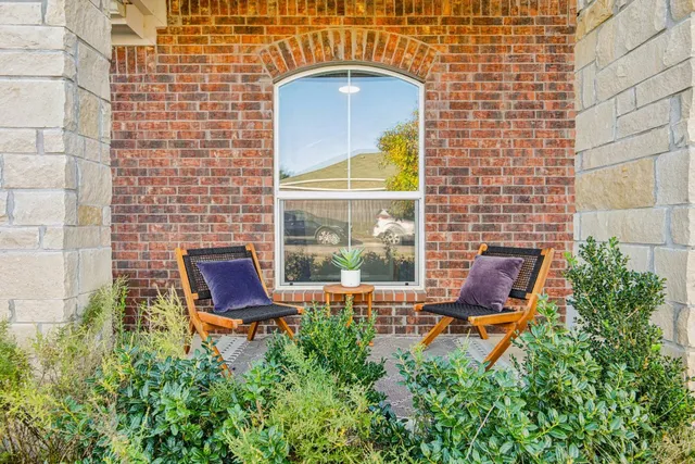 a backyard of a house with table and chairs