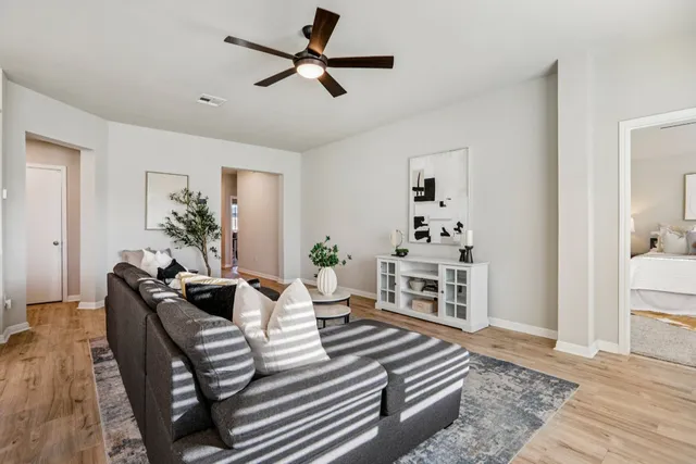 a living room with furniture a fireplace and a chandelier