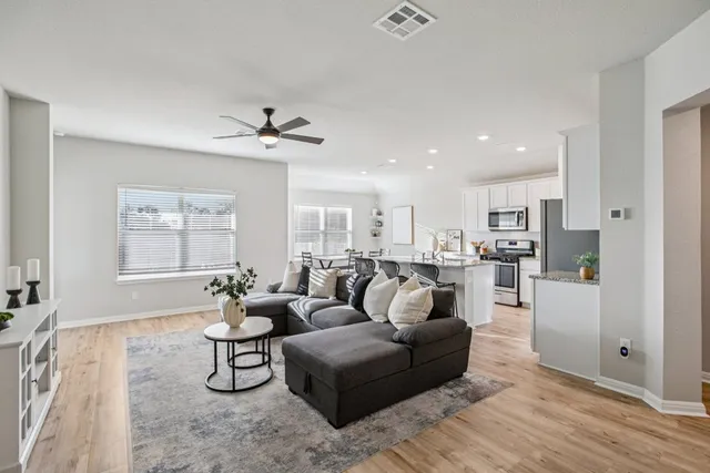 a living room with furniture and kitchen view