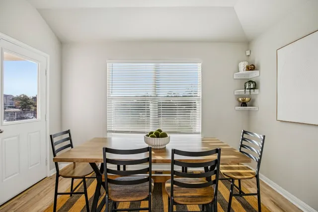 a dining room with furniture and window