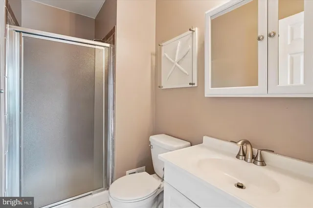 a bathroom with a toilet a sink and a mirror