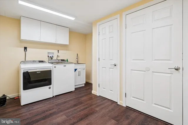 a view of a hallway with washer and dryer