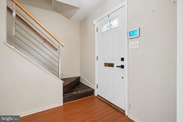 a view of an entryway with wooden floor