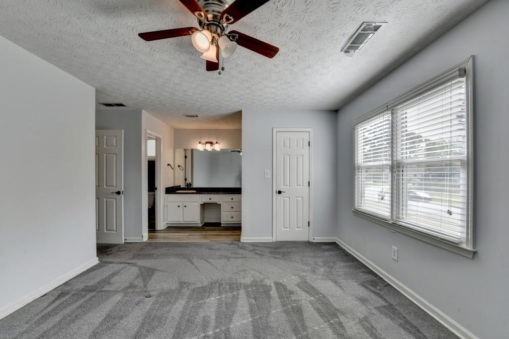 351 Cottonpatch Road Lawrenceville, GA 30046 - Photo 20 of 47 a view of an empty room with a window and a kitchen