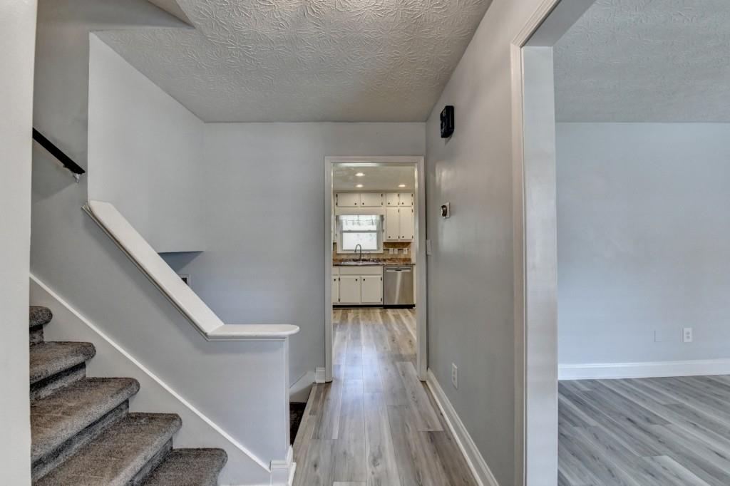 351 Cottonpatch Road Lawrenceville, GA 30046 - Photo 2 of 47 a view of a hallway with wooden floor and staircase