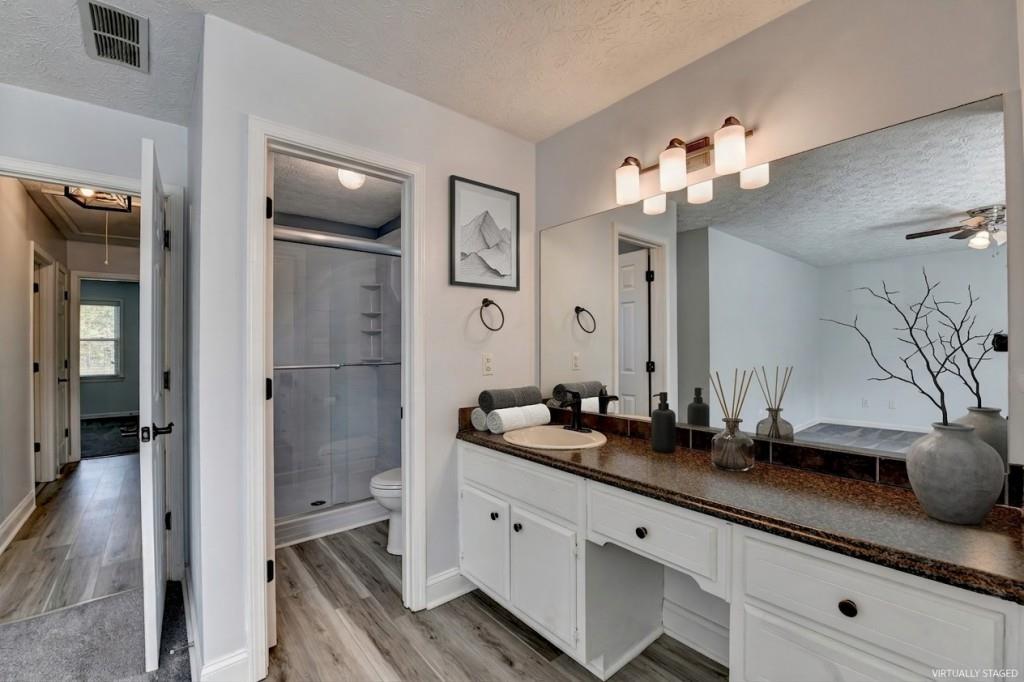 351 Cottonpatch Road Lawrenceville, GA 30046 - Photo 22 of 47 a spacious bathroom with a granite countertop sink and a mirror