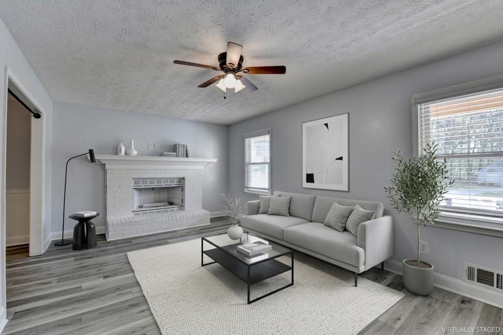 351 Cottonpatch Road Lawrenceville, GA 30046 - Photo 3 of 47 a living room with furniture and a fireplace