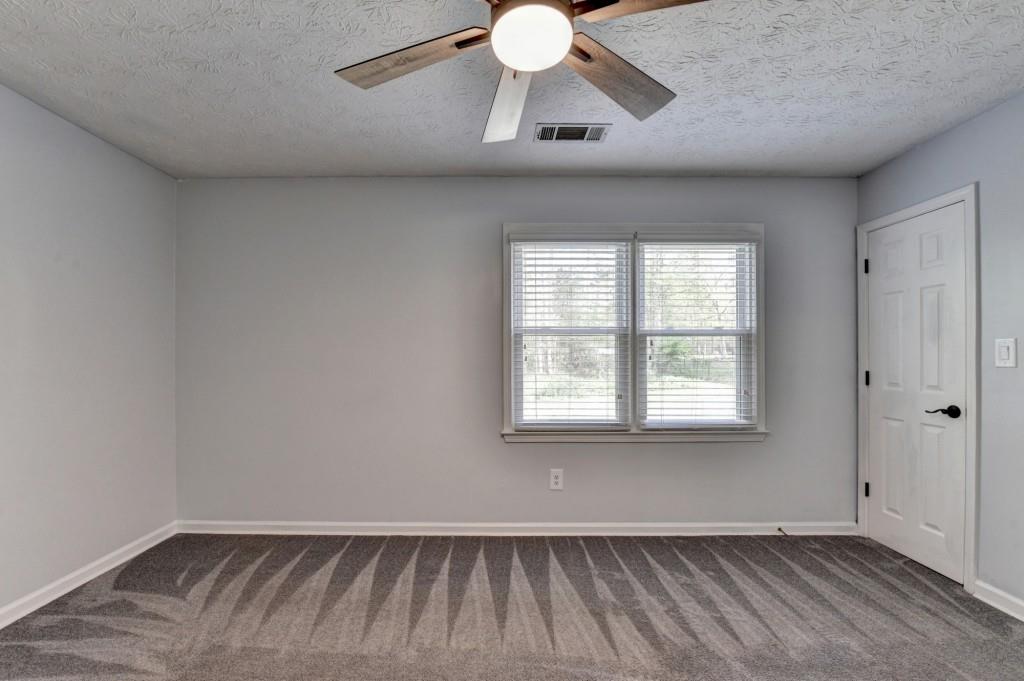 351 Cottonpatch Road Lawrenceville, GA 30046 - Photo 32 of 47 a view of an empty room with wooden floor and a window