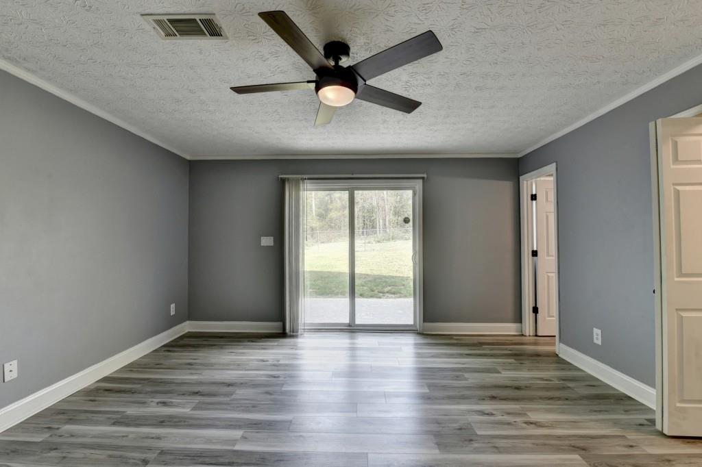 351 Cottonpatch Road Lawrenceville, GA 30046 - Photo 35 of 47 wooden floor in an empty room with a window