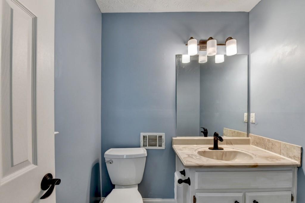 351 Cottonpatch Road Lawrenceville, GA 30046 - Photo 40 of 47 a bathroom with a toilet sink and mirror