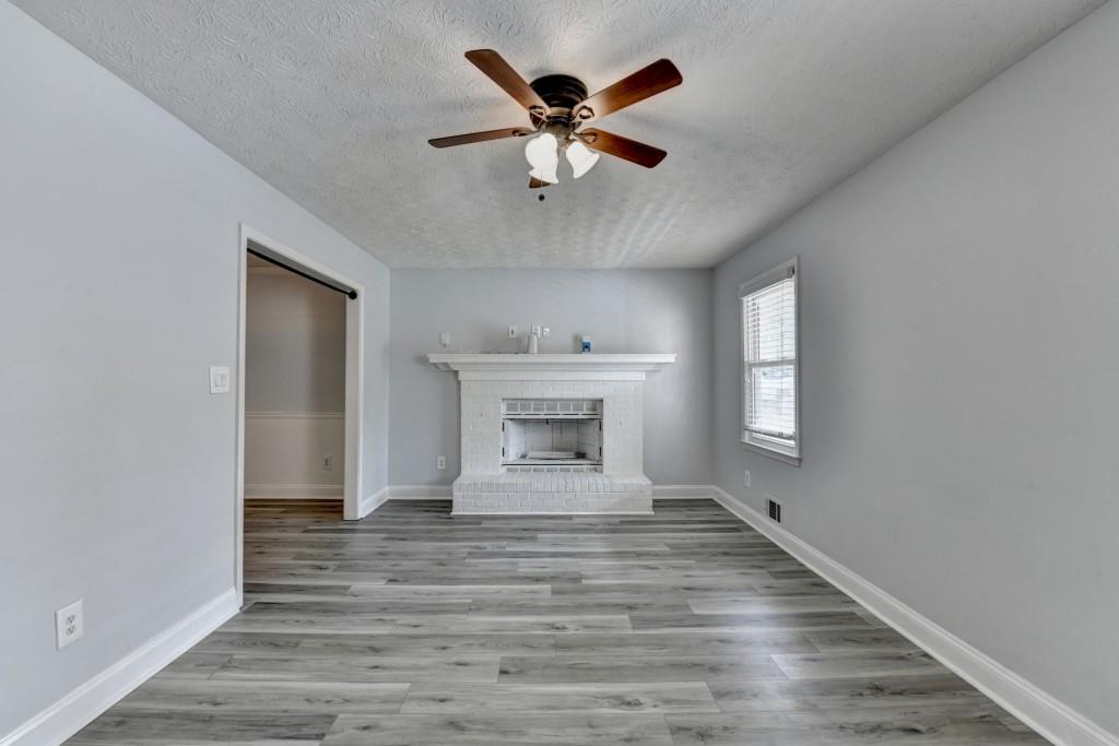 351 Cottonpatch Road Lawrenceville, GA 30046 - Photo 4 of 47 a view of an empty room with a window and wooden floor