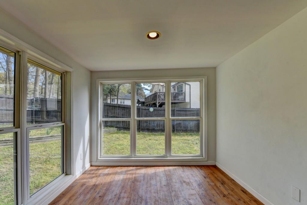 351 Cottonpatch Road Lawrenceville, GA 30046 - Photo 43 of 47 an empty room with wooden floor and windows