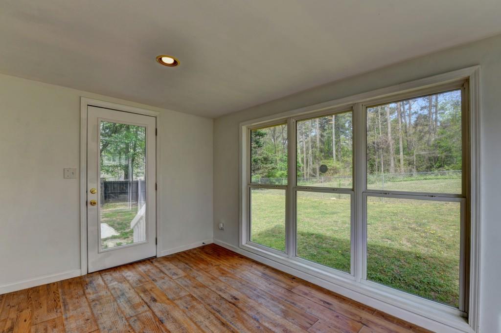 351 Cottonpatch Road Lawrenceville, GA 30046 - Photo 44 of 47 a view of an empty room with wooden floor and a window