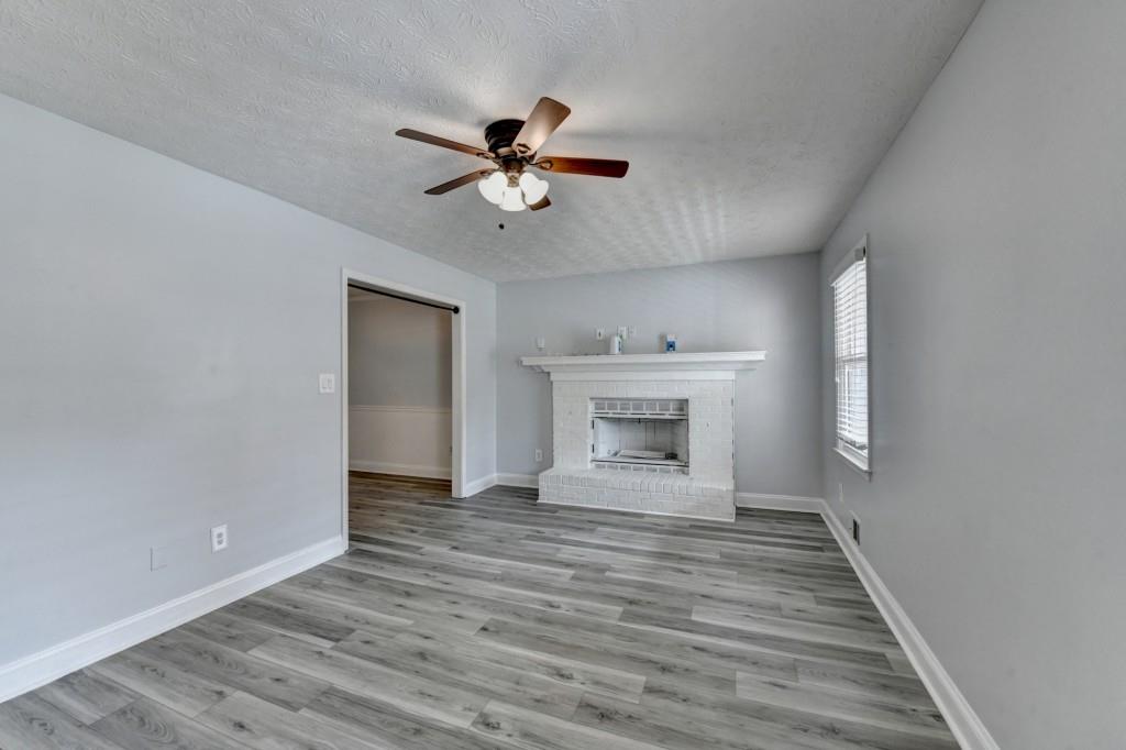 351 Cottonpatch Road Lawrenceville, GA 30046 - Photo 7 of 47 a view of an empty room with a fireplace and a window