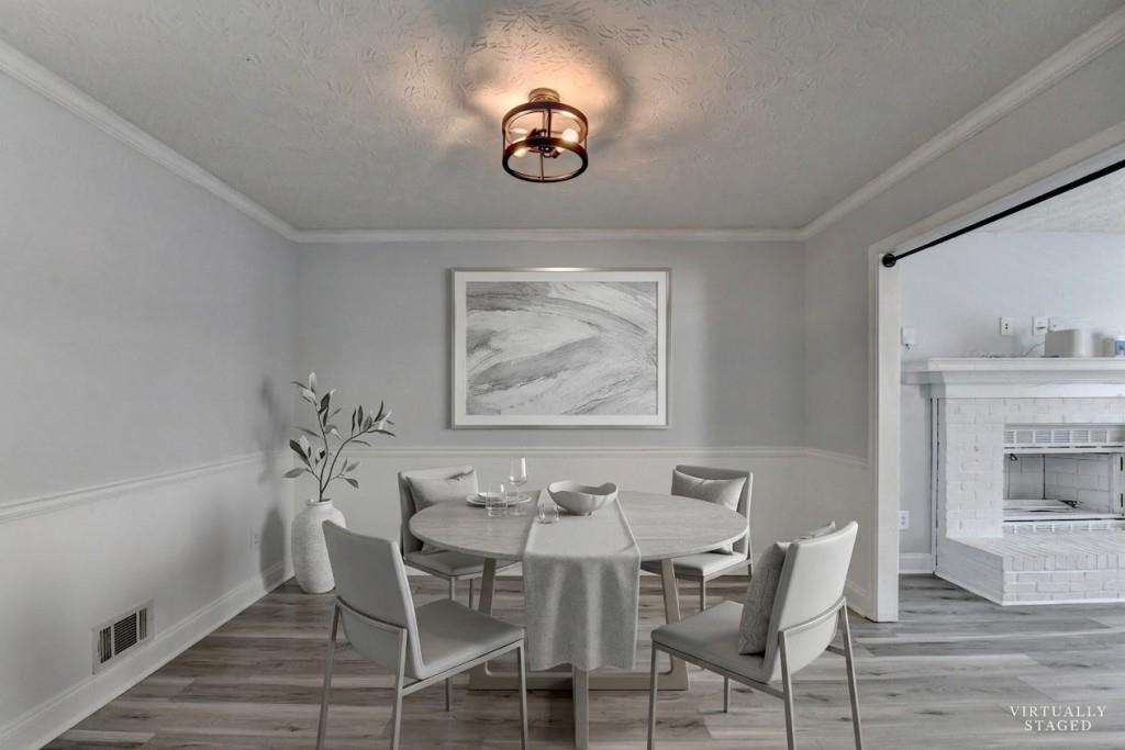 351 Cottonpatch Road Lawrenceville, GA 30046 - Photo 8 of 47 a dining room with furniture a chandelier and wooden floor