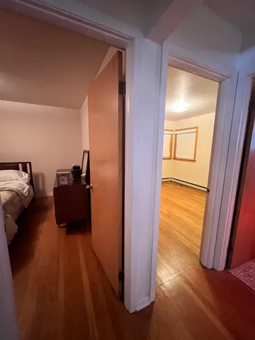 a room with wooden floor and furniture