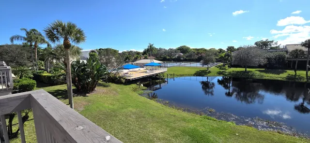 a view of a porch with furniture and wooden floor